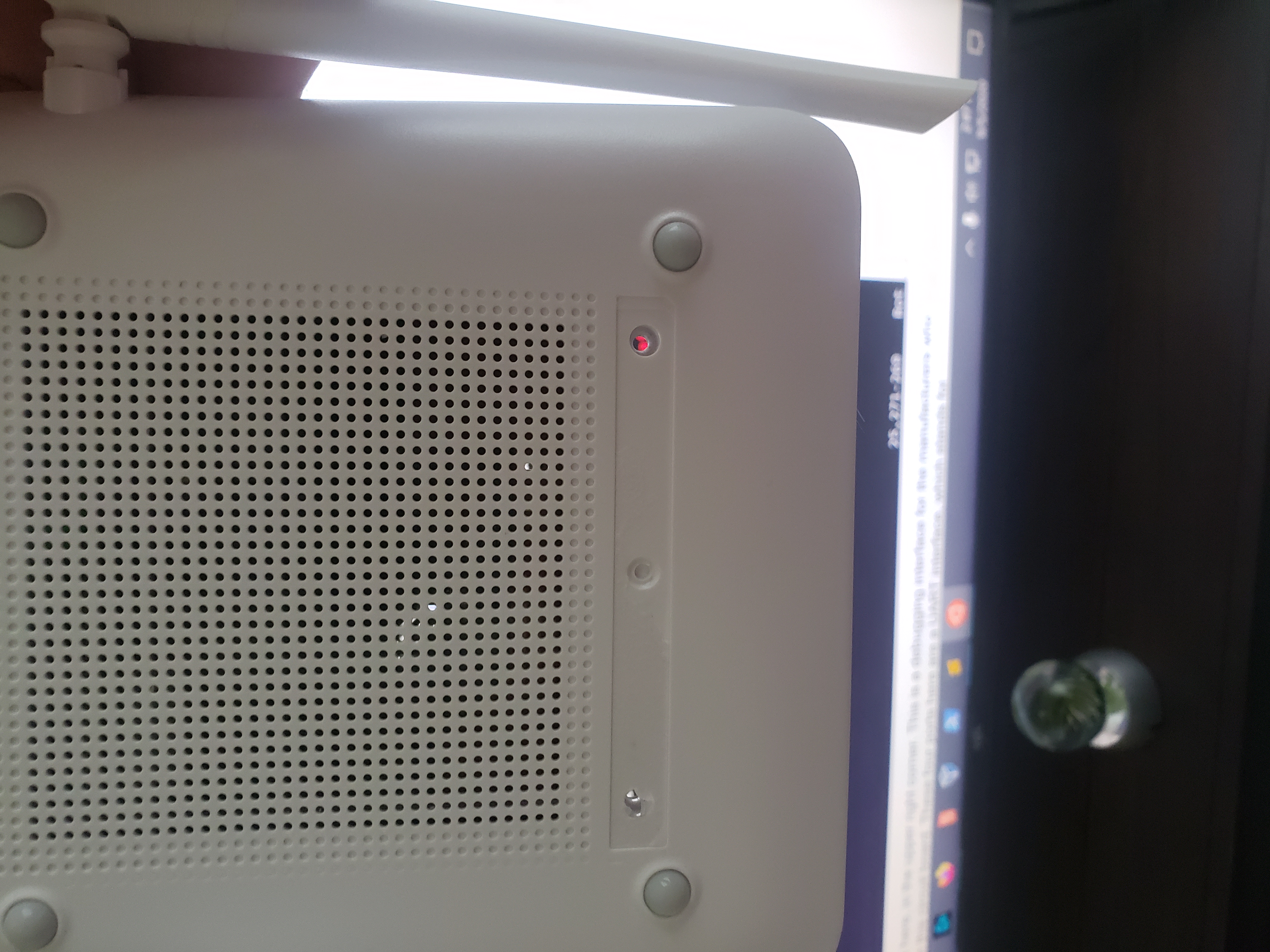 Bottom of the router. The red light shining through is where the screw used to be!